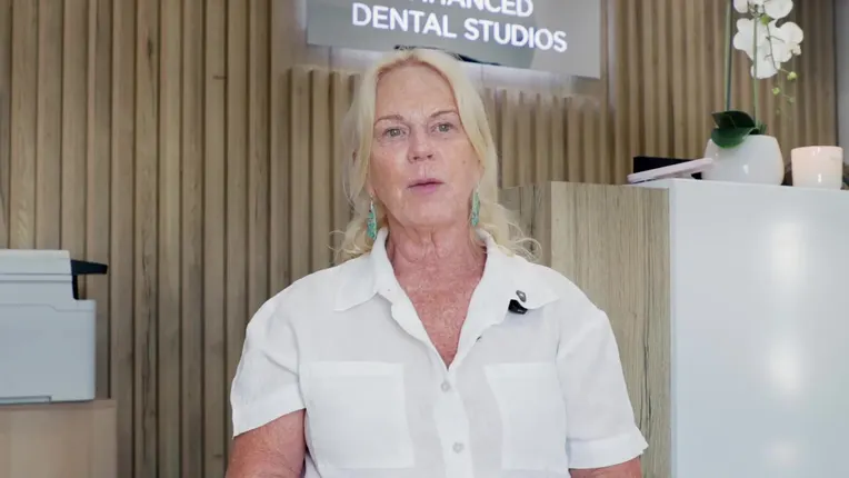 Debbie, an Enhanced Dental Studios patient, talking to camera in the clinic reception