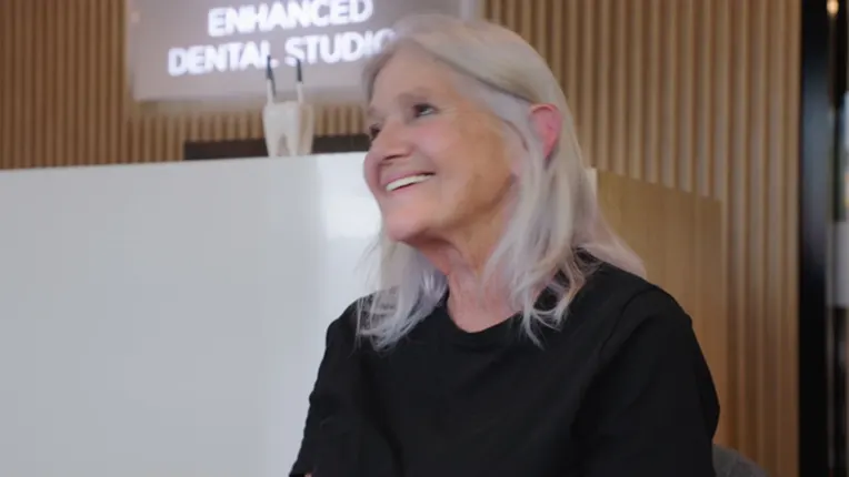 Margaret, an Enhanced Dental Studios patient, talking to camera in the clinic reception