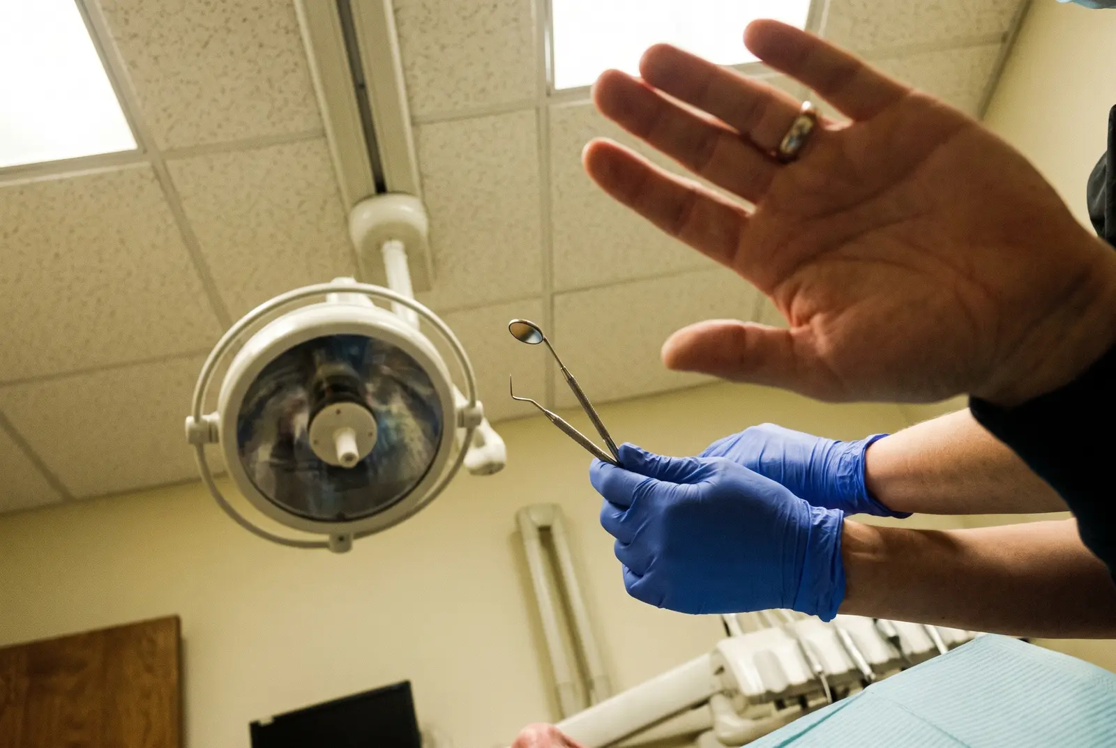 The view from the chair: a raised hand, and gloved hands pulling back and waiting.