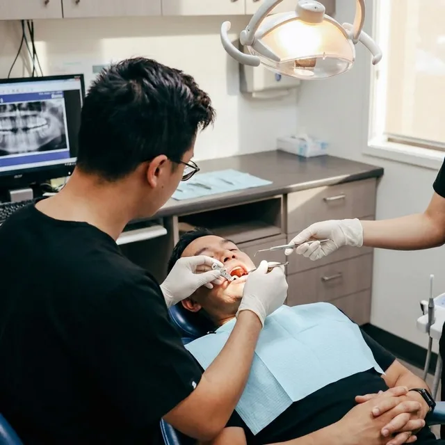 An Enhanced Dental Studios dentist placing a dental implant with a surgical guide.