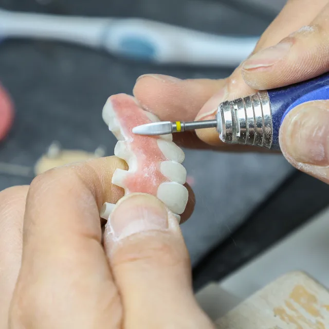 A denture being made by hand in the Enhanced Dental Studios lab.