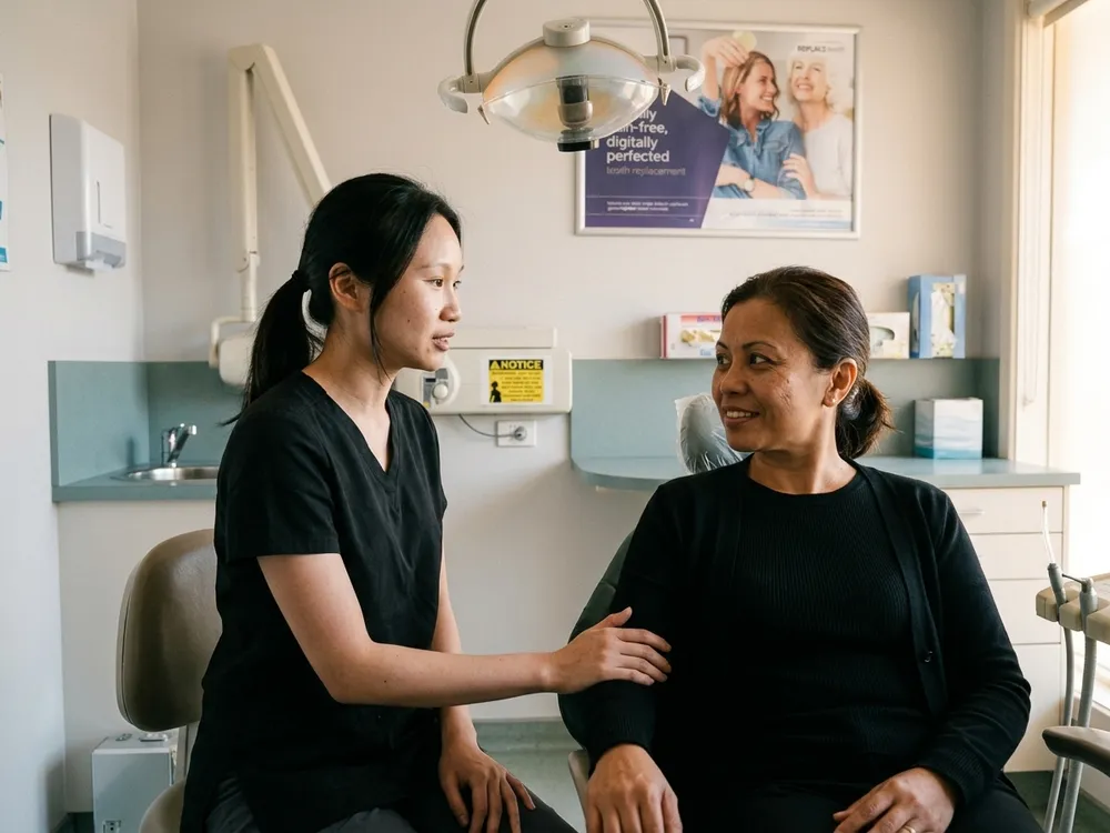 A nervous patient being reassured by an Enhanced Dental Studios clinician before a gentle check-up.