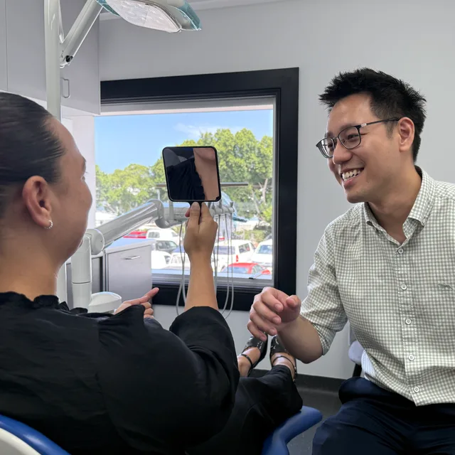 A clinician showing a patient their scan at an Enhanced Dental Studios clinic