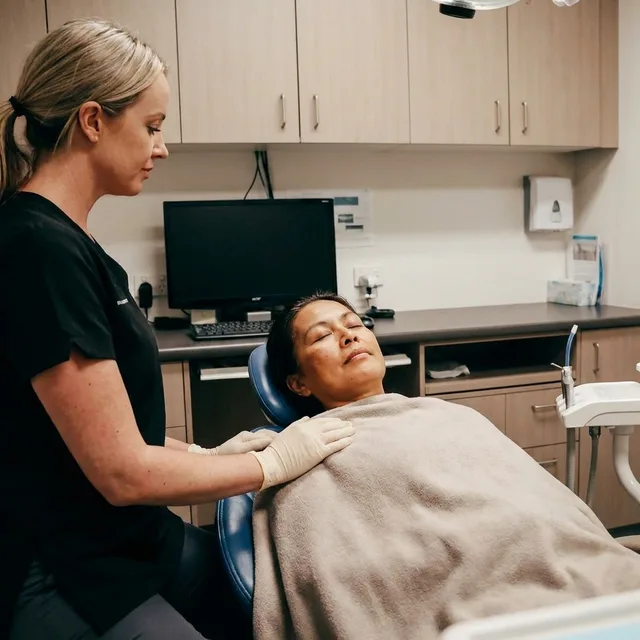 A patient resting comfortably during sedation at Enhanced Dental Studios.