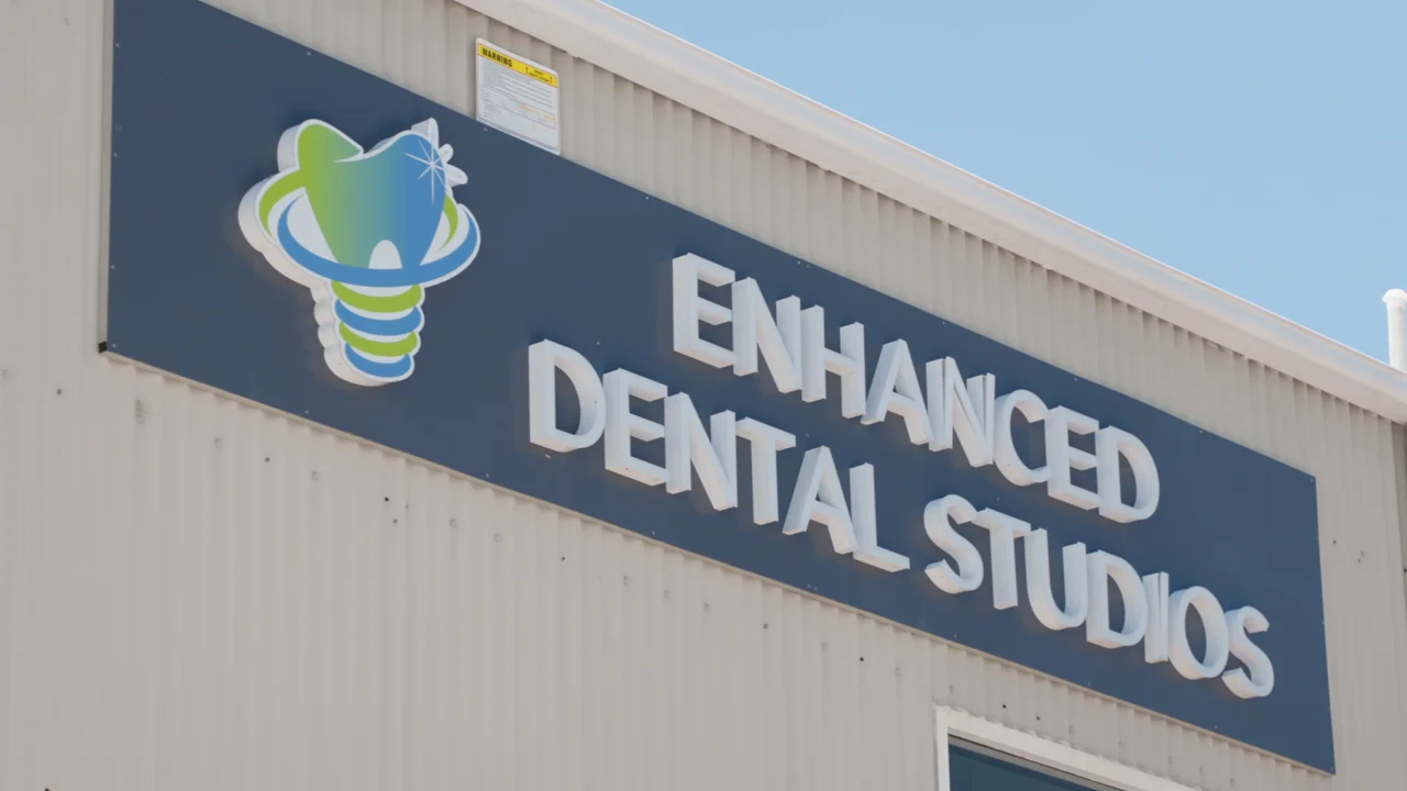 Enhanced Dental Studios signage at the Sanctuary Cove clinic.