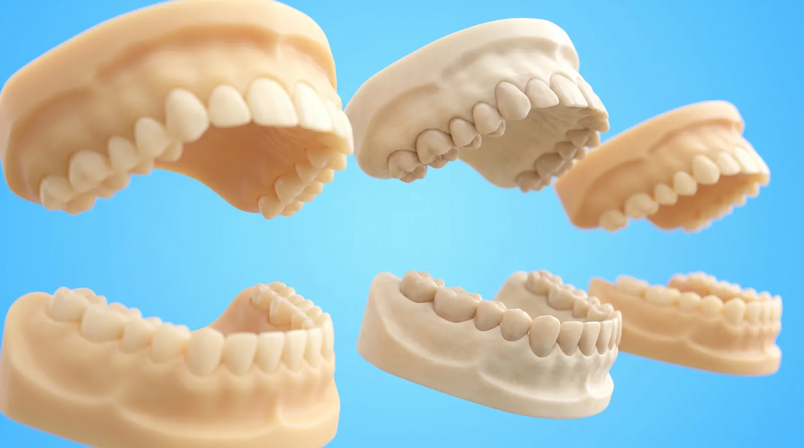 Several separate dental arch models spaced far apart from one another, unconnected