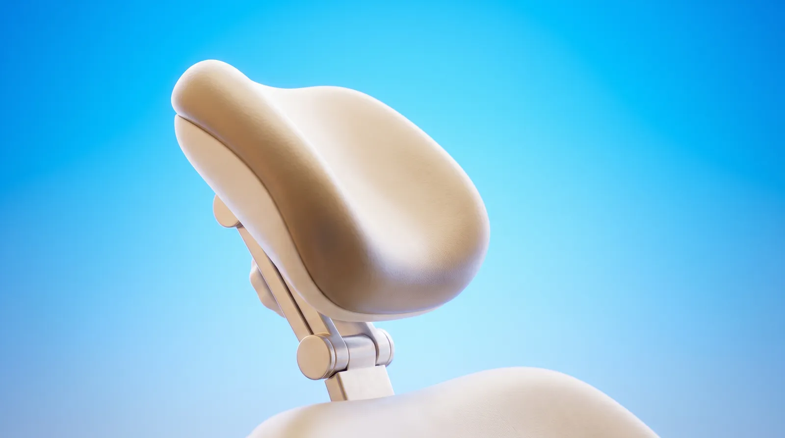 An empty dental chair headrest cushion alone in the frame, seen from a low angle