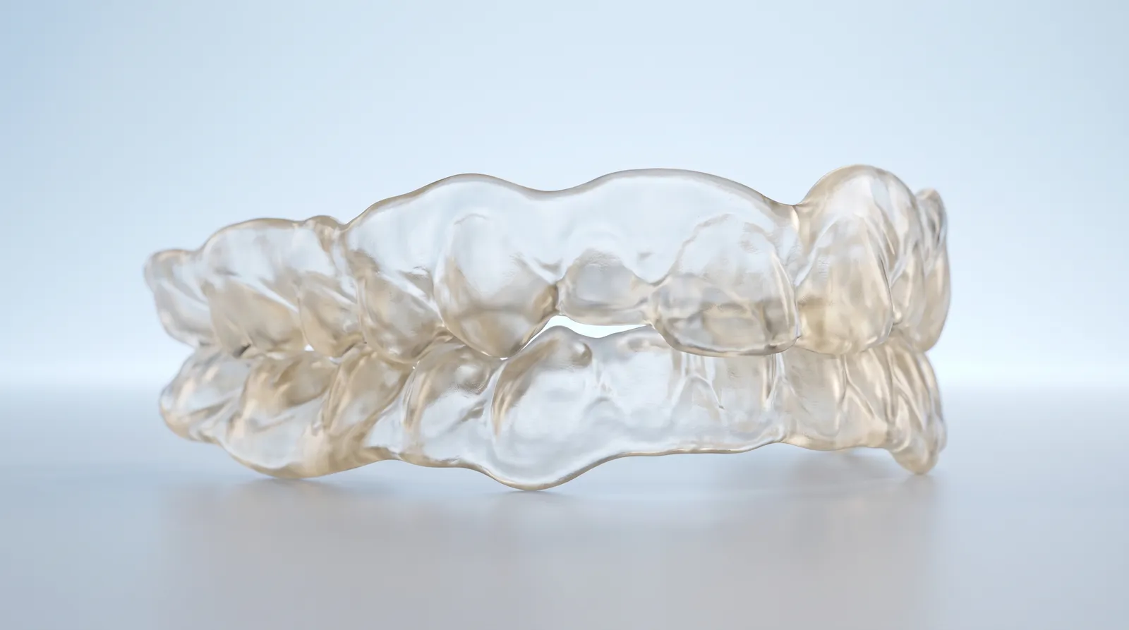 A thick bulky clear boil and bite mouthguard resting on its own, misshapen