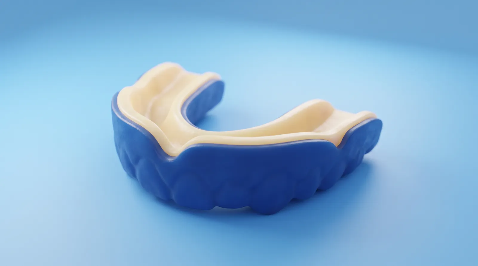 A slim custom sports mouthguard in two bold contrasting colours, resting on its own