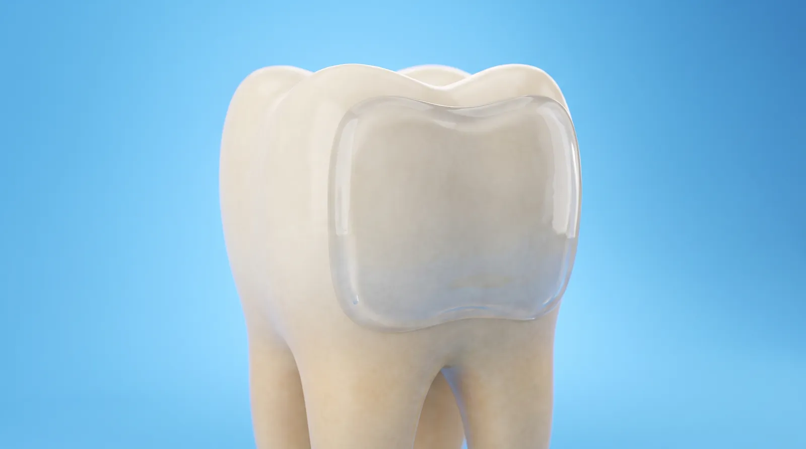 A thin clear layer of gel resting on the flat front surface of a single tooth model