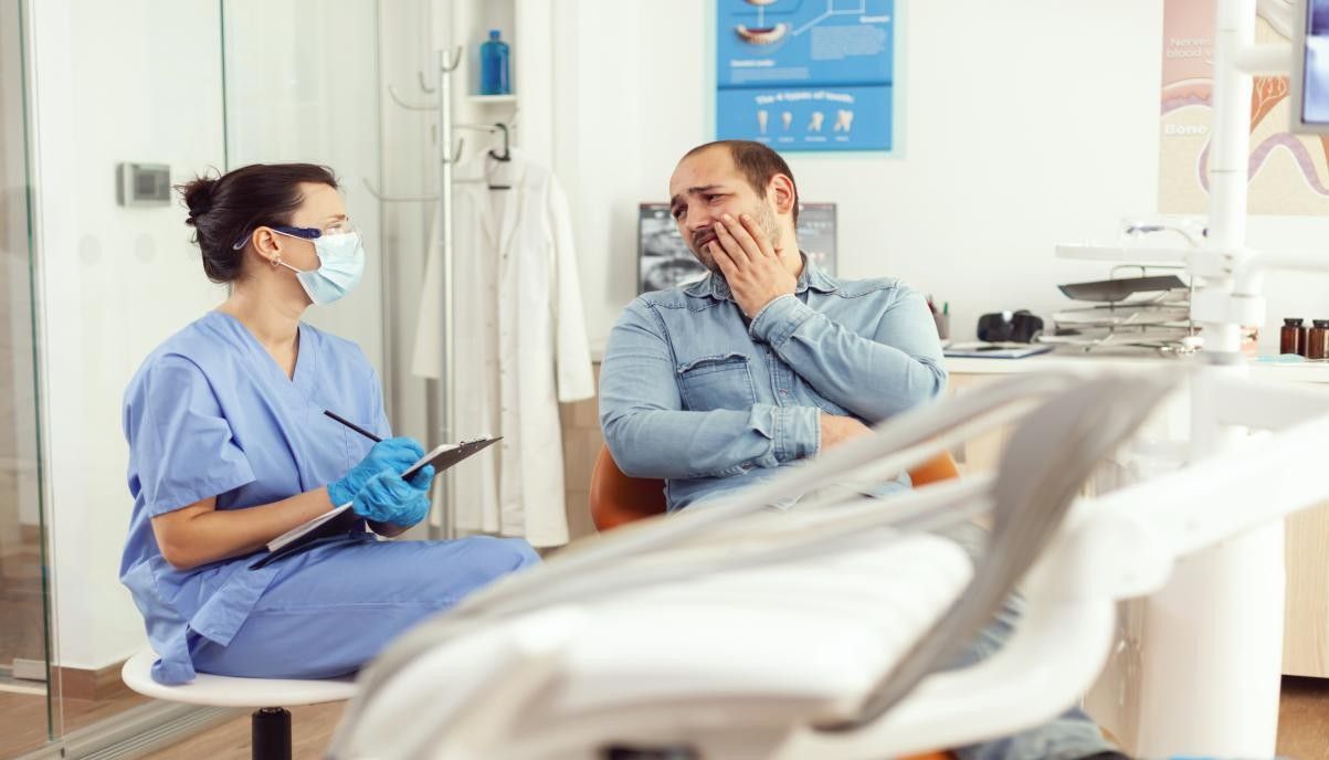 <strong>Dental pain rarely gives a warning. It can appear suddenly and without any obvious cause, leaving many people unsure of whether it warrants urgent attention. At <a href="https://www.enhanceddentalstudios.com.au/">Enhanced Dental Studios</a>, patients across Brisbane and the Gold Coast are encouraged to take warning signs seriously rather than waiting for the situation to worsen. Knowing what qualifies as a dental emergency can protect both oral health and overall wellbeing. This article outlines six clear signs that immediate dental attention is needed, so no one has to guess when it is time to act.</strong> <strong>Key Takeaways</strong> <ul> <li>Severe tooth pain that does not subside is a clear sign of an emergency</li> <li>A knocked out tooth can often be saved if treated within an hour</li> <li>Swelling in the jaw or gums may indicate a serious infection</li> <li>Bleeding that does not stop after dental trauma requires prompt care</li> <li>Delaying emergency dental treatment increases the risk of permanent damage</li> </ul> <ol> <li><strong> Severe or Persistent Toothache</strong></li> </ol> A mild ache after eating something cold is common. A throbbing, persistent pain that does not settle is not. A severe toothache often points to deep decay, a cracked tooth, or an infection at the root. Pain that radiates to the jaw, ear, or neck is particularly concerning. Ignoring this kind of discomfort rarely makes it go away. In most cases, the underlying problem worsens over time. <strong>Warning signs to watch for:</strong> <ul> <li>Pain that wakes a person from sleep and lingers for extended periods without relief</li> <li>Throbbing discomfort that spreads beyond the affected tooth into the surrounding areas</li> <li>Pain that increases with pressure, hot temperatures, or sweet foods and drinks</li> </ul> In many cases, <a href="https://www.enhanceddentalstudios.com.au/root-canal-therapy/">root canal therapy</a> may be required to address the source of the pain and prevent further damage to the tooth structure. <ol start="2"> <li><strong> A Knocked</strong> <strong>Out or Loose Tooth</strong></li> </ol> A <a href="https://www.ohv.org.au/?external-uuid=b81ebd89-e445-434a-89a6-7ebe73630040">knocked out tooth</a> is one of the most time-sensitive dental emergencies. When handled correctly and quickly, there is a genuine chance the tooth can be reinserted and saved. The window is narrow. Treatment within 30 to 60 minutes significantly improves the chances of a successful outcome. A tooth that is loose after an injury also requires urgent attention, as the surrounding tissue and bone may be damaged. <strong>Immediate steps to take:</strong> <ul> <li>Handle the tooth only by the crown, never by the root, to avoid damaging delicate tissue</li> <li>Rinse gently with clean water if the tooth is dirty, without scrubbing the surface</li> <li>Keep the tooth moist by placing it in milk or pressing it gently back into the socket</li> </ul> If the tooth cannot be saved, options such as dental implants can provide a long-lasting and natural-looking replacement. <ol start="3"> <li><strong> Swelling in the Jaw, Face, or Gums</strong></li> </ol> Swelling that appears suddenly around the jaw, cheeks, or gums should never be dismissed. It often signals an infection, abscess, or a more serious underlying problem. A dental abscess is a collection of pus caused by a bacterial infection. Left untreated, it can spread to the neck, jaw, or even the brain. This makes prompt treatment essential rather than optional. <strong>Signs that point to a dental abscess:</strong> <ul> <li>Visible swelling in one area of the face or gum that feels warm to the touch</li> <li>A persistent bad taste or foul smell in the mouth that does not improve with brushing</li> <li>Fever, difficulty swallowing, or a general feeling of illness alongside dental discomfort</li> </ul> Seeking <a href="https://www.qld.gov.au/health/staying-healthy/oral-health/visiting-the-dentist/emergency-dental">emergency dental</a> care as soon as swelling develops is strongly advised. <ol start="4"> <li><strong> Uncontrolled Bleeding from the Mouth</strong></li> </ol> Some bleeding after a dental procedure or minor injury is expected. Bleeding that does not slow or stop after 10 to 15 minutes of gentle pressure is not. This type of bleeding can result from a deep laceration, a dislodged blood clot following an extraction, or trauma to the gums. Prolonged bleeding also increases the risk of dry socket, which is a painful condition that requires professional treatment. <strong>When bleeding becomes an emergency:</strong> <ul> <li>Bleeding continues beyond 15 to 20 minutes despite firm, consistent pressure being applied</li> <li>Blood is accompanied by severe pain, swelling, or signs of infection in the area</li> <li>Bleeding occurred after a trauma such as a fall, sports injury, or collision</li> </ul> <ol start="5"> <li><strong> A Cracked, Chipped, or Broken Tooth</strong></li> </ol> A small chip without any discomfort may not always be urgent. A crack that reaches the gumline or a break that exposes the inner pulp of the tooth is a different matter entirely. Exposed pulp is extremely sensitive and highly vulnerable to infection. Without timely care, a cracked or broken tooth can deteriorate rapidly and may ultimately require extraction if left too long. <strong>Situations that require same-day attention:</strong> <ul> <li>A visible crack that extends down the tooth towards or below the gumline</li> <li>Sharp or jagged edges that are cutting the tongue, cheek, or surrounding soft tissue</li> <li>Sudden sensitivity to temperature or biting that follows an injury to the tooth</li> </ul> Restorative options such as dental crowns can protect a damaged tooth and restore both function and appearance when treated promptly. <ol start="6"> <li><strong> Lost or Damaged Filling, Crown, or Restoration</strong></li> </ol> Losing a filling or crown can feel minor at first. However, the tooth structure underneath is now exposed and unprotected. Without the restoration in place, bacteria can quickly reach the inner layers of the tooth. Food particles can become trapped, and the risk of pain and infection rises significantly. The longer the tooth remains exposed, the more complex the repair may become. <strong>Signs that a lost restoration needs urgent attention:</strong> <ul> <li>Sudden sensitivity or pain in the area where a filling or crown was previously placed</li> <li>A visible hole or rough surface where the restoration has fallen out or broken away</li> <li>Discomfort when chewing or biting down in that specific area of the mouth</li> </ul> Replacing a lost filling with a quality <a href="https://www.enhanceddentalstudios.com.au/tooth-fillings/">tooth filling</a> quickly helps prevent deeper decay and avoids the need for more invasive treatment later. <strong>Why Acting Quickly Makes a Difference</strong> A dental emergency is not just about pain. It is about preventing a manageable problem from becoming a serious one. <strong>When prompt treatment is sought:</strong> <ul> <li>Teeth that might otherwise require extraction have a much higher chance of being saved</li> <li>Infections are contained before spreading to nearby teeth, gums, or other structures</li> <li>Treatment tends to be simpler, less invasive, and more cost-effective overall</li> </ul> Routine check-ups also play an important role. Regular <a href="https://www.healthdirect.gov.au/teeth-cleaning">teeth cleaning</a> and professional assessments help catch early warning signs before a situation escalates into a genuine emergency. <strong>Conclusion</strong> Dental emergencies can be stressful and frightening. Recognising the signs early and acting without delay is the single most effective way to protect both the tooth and overall health. At Enhanced Dental Studios, our team is equipped to handle urgent situations with care, skill, and efficiency across multiple Brisbane and Gold Coast locations. If any of these warning signs sound familiar, do not wait. <a href="tel:1800833844">Get in touch with us</a> today to book an appointment or speak with our team about your concerns. <strong>FAQs</strong> <ol> <li><strong> What qualifies as a dental emergency?</strong></li> </ol> A dental emergency includes any situation involving severe pain, uncontrolled bleeding, swelling, a knocked out tooth, or a broken restoration that causes discomfort. If symptoms are sudden, worsening, or affecting daily life, same-day dental care is advised. <ol start="2"> <li><strong> Can a dental abscess go away on its own?</strong></li> </ol> No. A dental abscess will not resolve without professional treatment. Antibiotics may reduce symptoms temporarily, but the infection source must be properly treated by a dentist to prevent it from spreading. <ol start="3"> <li><strong> What should be done with a tooth that has been knocked out?</strong></li> </ol> Handle the tooth by the crown only, rinse gently with water if needed, and try to reinsert it into the socket or store it in milk. Seek emergency dental care within 30 to 60 minutes for the best chance of saving the tooth. <ol start="4"> <li><strong> Is a cracked tooth always a dental emergency?</strong></li> </ol> Not always. A small, superficial chip without pain may be able to wait for a regular appointment. However, a crack that extends to the gumline, causes sharp pain, or exposes the inner tooth requires urgent care. <ol start="5"> <li><strong> How long can an emergency dental appointment take?</strong></li> </ol> Emergency appointments are focused on stabilising the issue and relieving pain. Depending on the situation, the initial visit may take anywhere from 30 minutes to over an hour, followed by further treatment as required. <ol start="6"> <li><strong> Can a toothache resolve without visiting a dentist?</strong></li> </ol> A mild toothache may ease temporarily, but the underlying cause rarely disappears without treatment. Persistent or worsening tooth pain should always be assessed by a dental professional to rule out decay, infection, or structural damage.